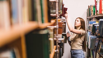 back-school-concept-with-woman-studying-library